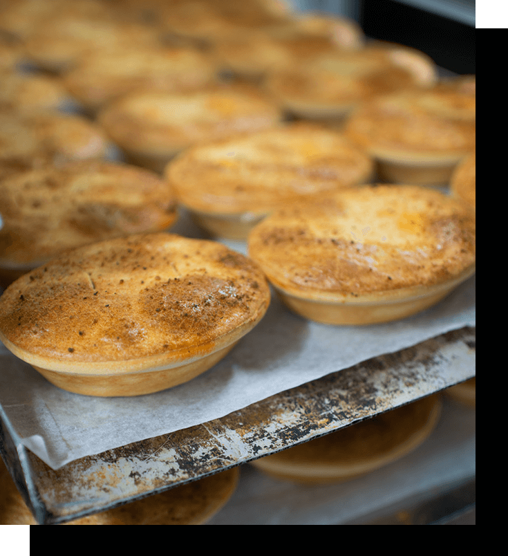 Meat pies lined up in the oven
